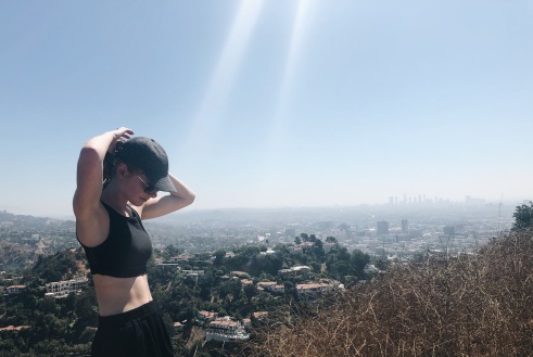Photo of Eline Millenaar, on top of a hill overlooking Los Angeles after a hike at Woodland Canyon